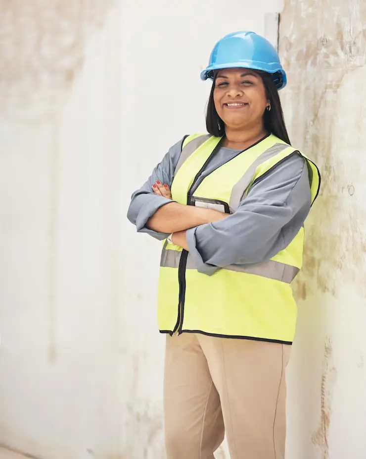 running this site with confidence cropped portrait attractive young female construction worker standing with her arms folded site_590464 59443
