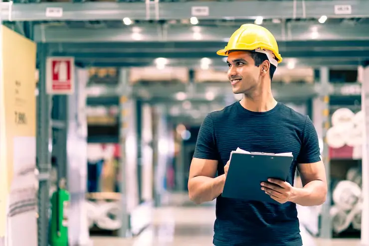 smart indian engineer man wearing safety helmet doing stock tick check cardboard stock product management factory warehouse background_609648 1515
